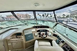 Slide: The Image of 2001 Sea Ray Sundancer 540 yacht cockpit with marina view and palm trees. - 33