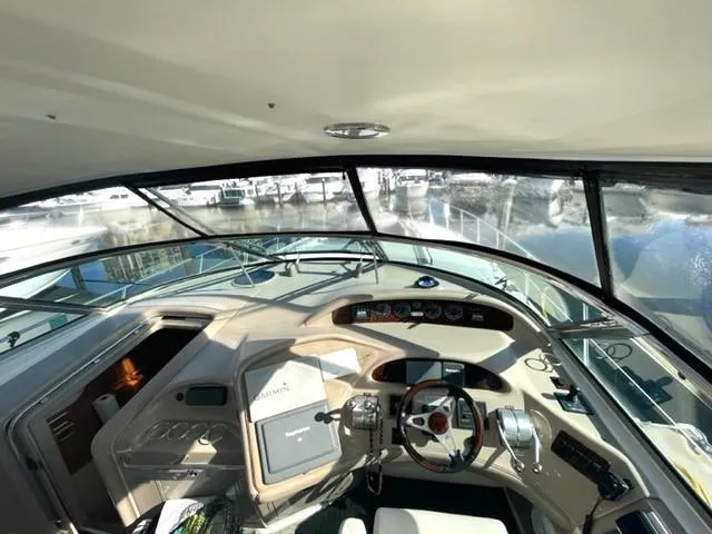 Slide: The Image of 2001 Sea Ray Sundancer 540 yacht cockpit with steering wheel and control panel. - 34