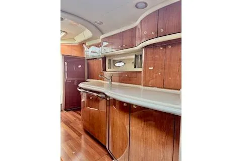 Slide: The Image of 2001 Sea Ray Sundancer 540 yacht interior with wooden cabinetry and sleek countertops. - 7