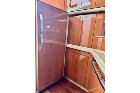 Slide: The Image of 2001 Sea Ray Sundancer 540 yacht kitchen with wooden cabinets and modern design. - 8