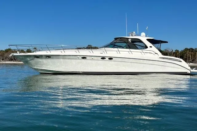 Slide: The Image of 2001 Sea Ray Sundancer 540 yacht on calm water under clear blue sky. - 94
