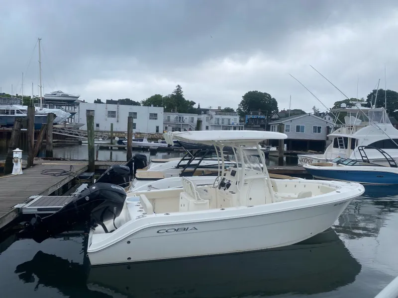 The Image of 2023 Cobia 240 Center Console boat docked at marina. - 0