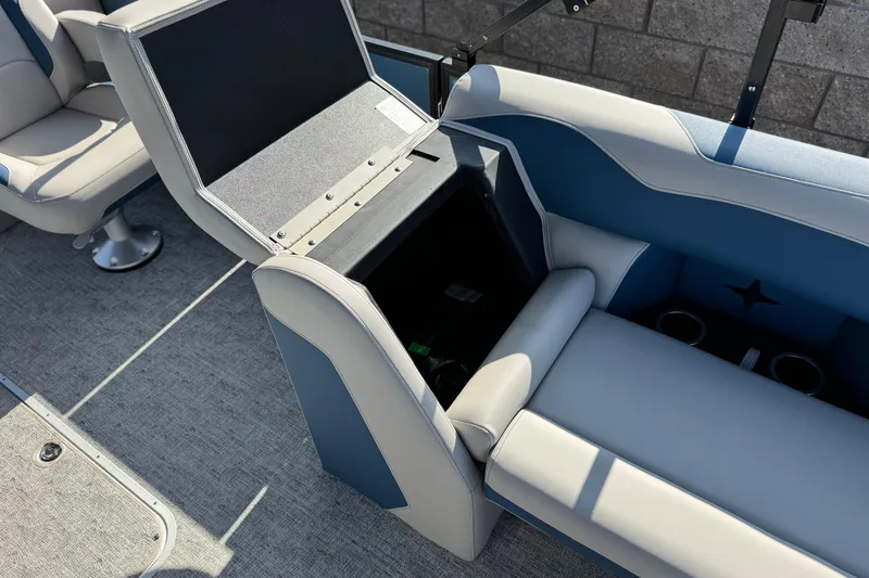 Slide: The Image of Berkshire 22RFX LE 2026 boat interior with open storage compartment and seating. - 12