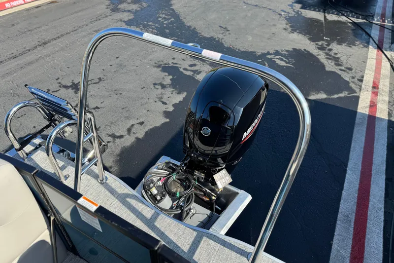 Slide: The Image of 2026 Berkshire 22RFX LE boat with Mercury outboard motor, docked on wet pavement. - 20