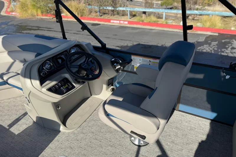 Slide: The Image of 2026 Berkshire 22RFX LE boat interior with steering wheel and captain's chair. - 22