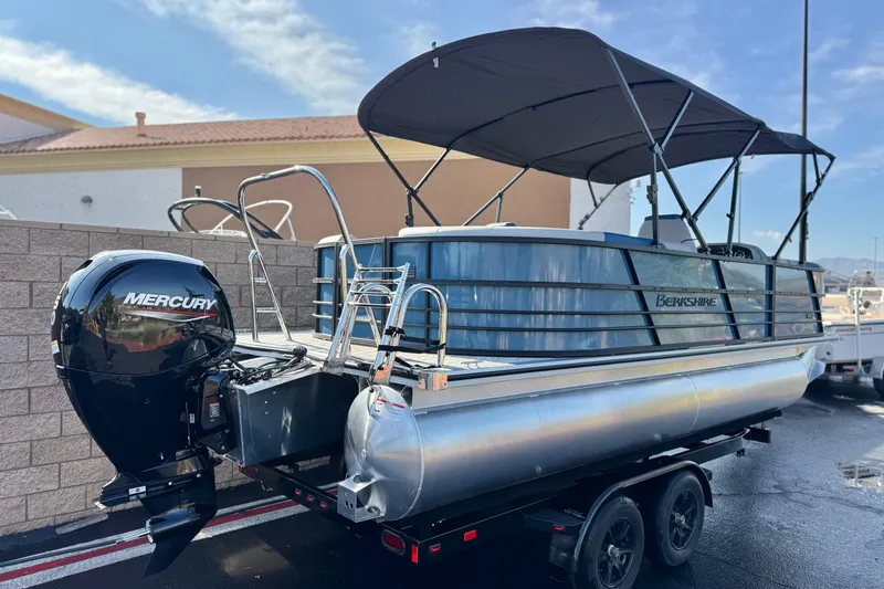 Slide: The Image of 2026 Berkshire 22RFX LE pontoon boat with Mercury outboard engine and canopy. - 5