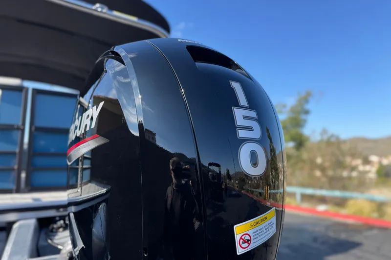 Slide: The Image of Mercury 150 outboard motor on 2026 Berkshire 22RFX LE boat, sunny day background. - 7