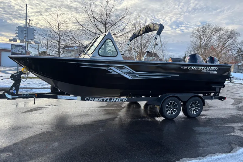 Slide: The Image of 2026 Crestliner 2050 Commander boat on trailer, parked on wet pavement, winter background. - 1