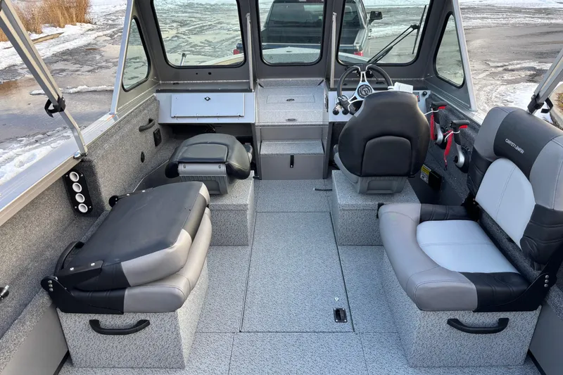 Slide: The Image of Interior of 2026 Crestliner 2050 Commander boat with seating and steering wheel. - 11