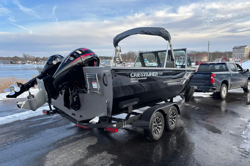 Slide: The Image of 2026 Crestliner 2050 Commander boat on trailer, parked near a lake. - 12