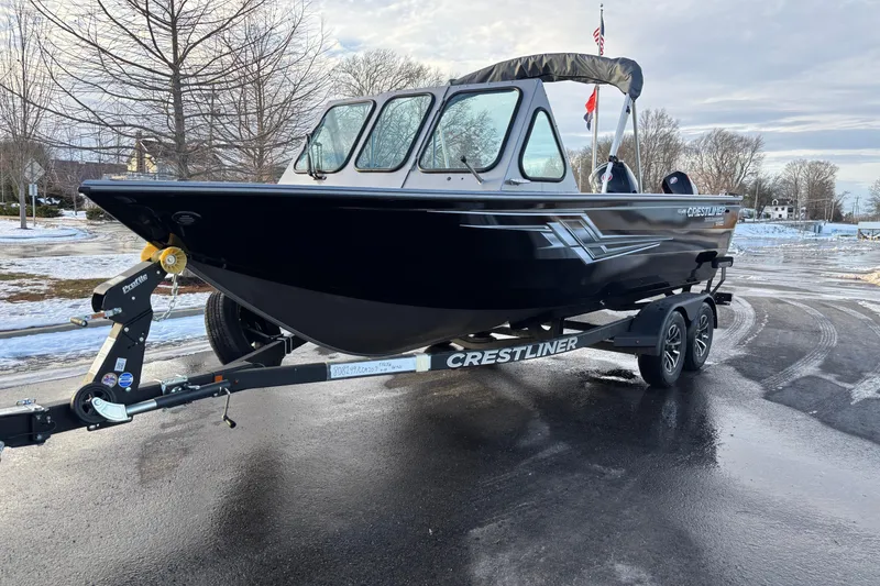 Slide: The Image of 2026 Crestliner 2050 Commander boat on trailer, parked on a snowy road. - 13