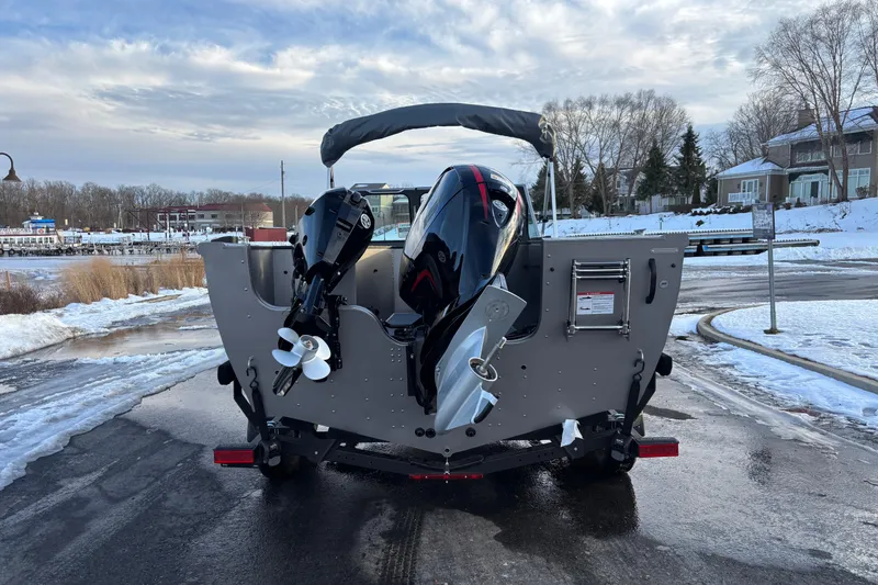 Slide: The Image of 2026 Crestliner 2050 Commander boat with dual outboard motors on snowy dock. - 14