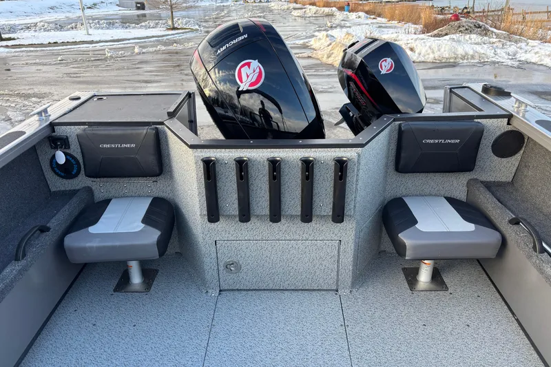 Slide: The Image of 2026 Crestliner 2050 Commander boat interior with dual Mercury engines, seating, and rod holders. - 2