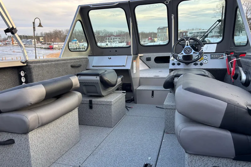 Slide: The Image of Interior of 2026 Crestliner 2050 Commander boat with modern seating and steering console. - 3