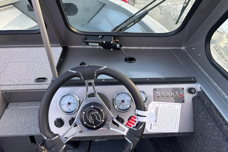 Slide: The Image of 2026 Crestliner 2050 Commander dashboard with steering wheel and gauges. - 6