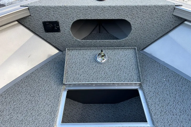 Slide: The Image of 2026 Crestliner 2050 Commander boat interior with storage compartment and control panel. - 9