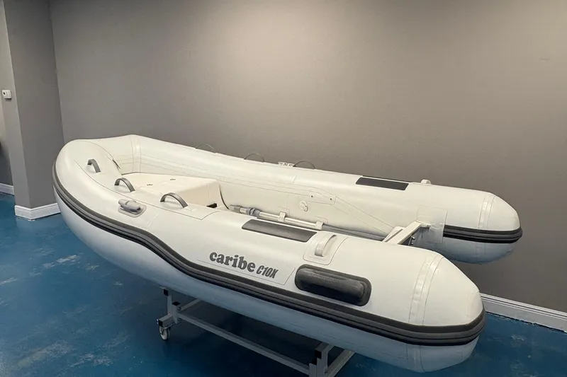 Slide: The Image of 2024 Caribe c-10X inflatable boat displayed in showroom with contact information. - 3