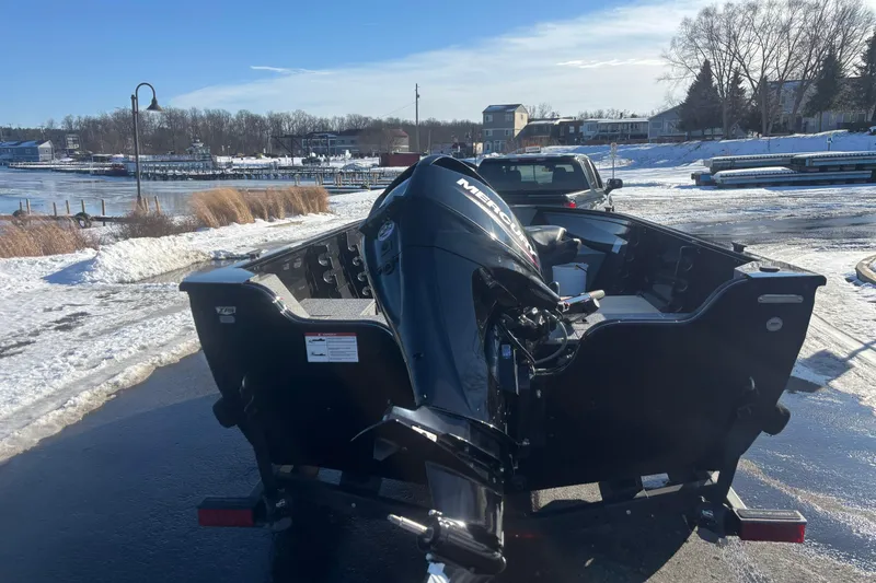 Slide: The Image of 2026 Crestliner 1650 Kodiak Tiller boat on snowy lakeside, rear view. - 10