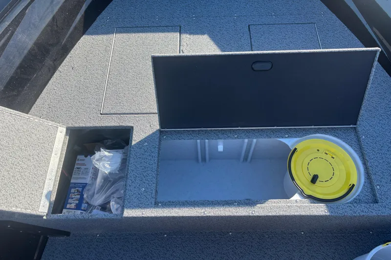 Slide: The Image of 2026 Crestliner 1650 Kodiak Tiller boat storage compartments with organized gear and accessories. - 3