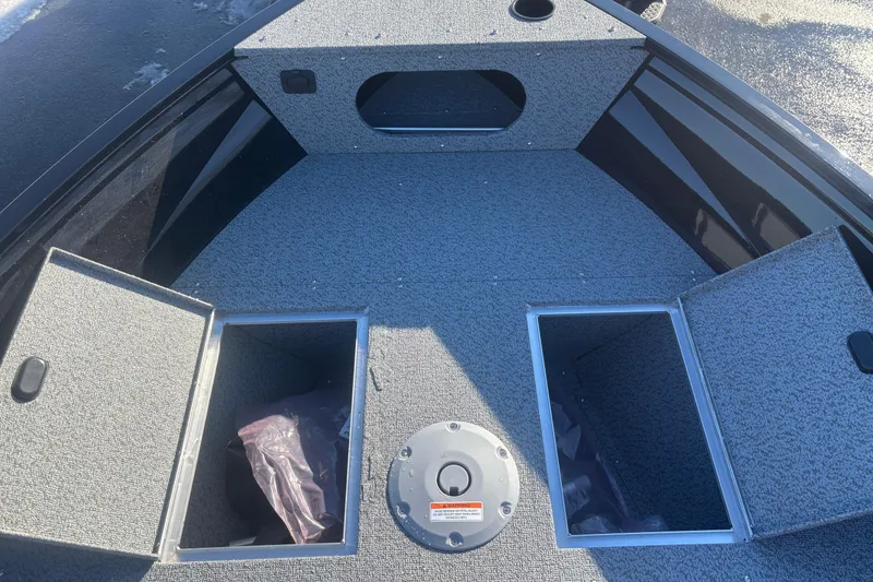 Slide: The Image of 2026 Crestliner 1650 Kodiak Tiller boat interior with open storage compartments. - 4