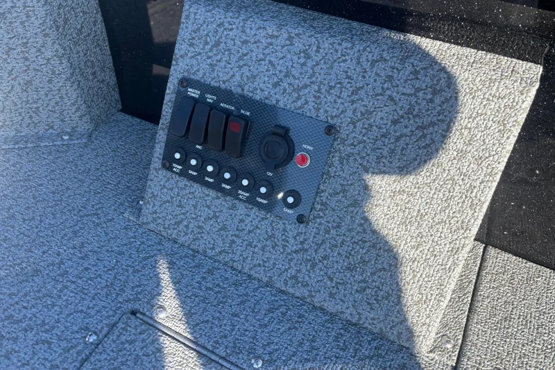 Slide: The Image of Control panel of 2026 Crestliner 1650 Kodiak Tiller boat, featuring switches and outlets. - 7