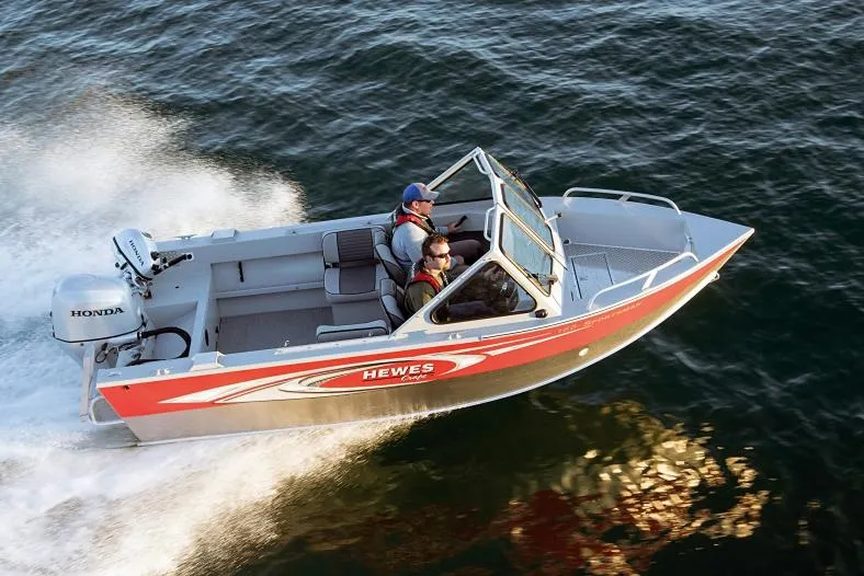 Slide: The Image of Manufacturer Provided Image: 2026 Hewescraft 180 Sportsman boat cruising on water with two passengers. - 2