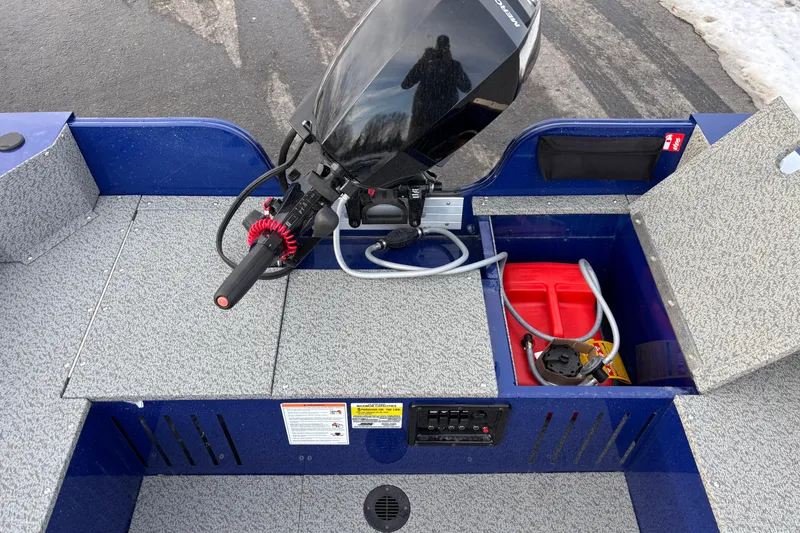 Slide: The Image of 2026 Crestliner 1650 Discovery Tiller boat interior with motor and storage compartments. - 3