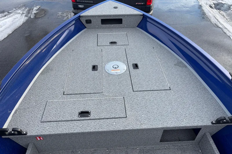 Slide: The Image of 2026 Crestliner 1650 Discovery Tiller boat deck, featuring storage compartments and a sleek design. - 4