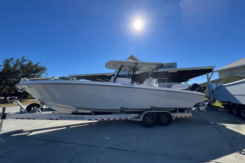 The Image of 2023 Fountain 34 Tournament Edition boat on trailer under bright sun. - 1