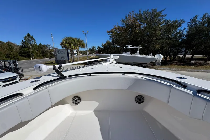 Slide: The Image of 2023 Fountain 34 Tournament Edition boat, white deck, parked outdoors under clear blue sky. - 17