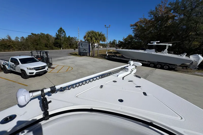 Slide: The Image of 2023 Fountain 34 Tournament Edition boat on trailer, parked near a white truck. - 19