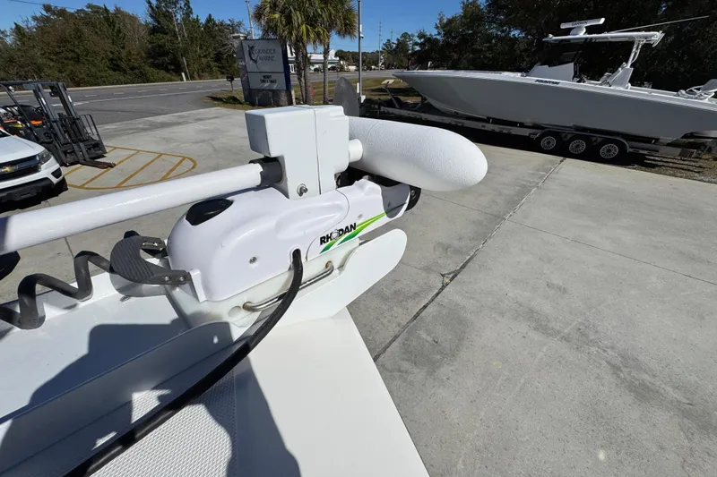 Slide: The Image of 2023 Fountain 34 Tournament Edition boat with Rhodan trolling motor in a marina setting. - 20