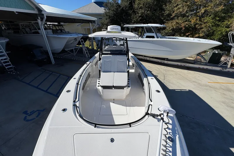 Slide: The Image of 2023 Fountain 34 Tournament Edition boat in a marina, showcasing sleek design and spacious deck. - 22