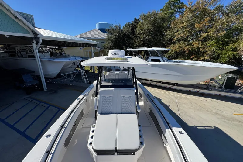 Slide: The Image of 2023 Fountain 34 Tournament Edition boat in marina, surrounded by other vessels. - 23