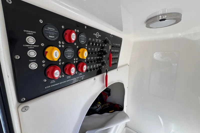 Slide: The Image of Control panel of 2023 Fountain 34 Tournament Edition boat, featuring switches and indicators. - 27