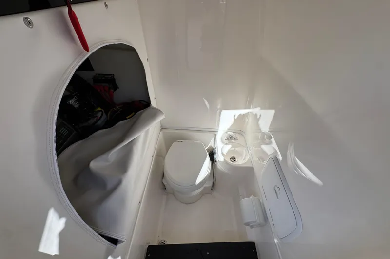 Slide: The Image of Interior of 2023 Fountain 34 Tournament Edition boat with compact toilet and storage area. - 28