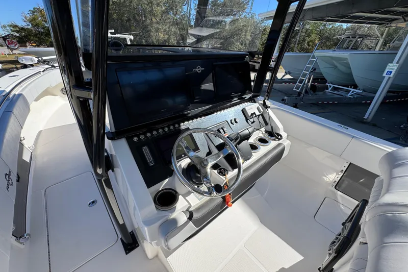 Slide: The Image of 2023 Fountain 34 Tournament Edition boat cockpit with modern steering and controls. - 32