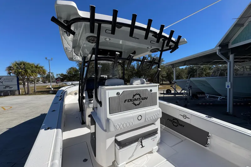 Slide: The Image of 2023 Fountain 34 Tournament Edition boat with rod holders and seating, docked outdoors. - 37