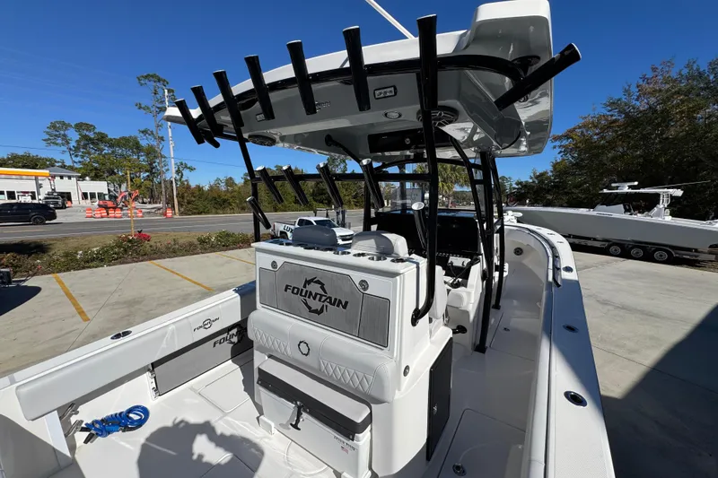 Slide: The Image of 2023 Fountain 34 Tournament Edition boat, sleek design, docked outdoors under clear blue sky. - 39