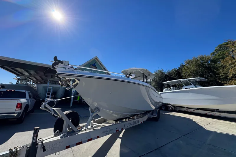 Slide: The Image of 2023 Fountain 34 Tournament Edition boat on trailer under bright sun. - 4