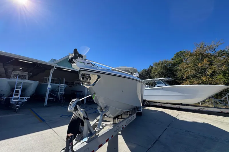 Slide: The Image of 2023 Fountain 34 Tournament Edition boat on trailer under clear blue sky. - 5