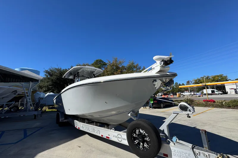 Slide: The Image of 2023 Fountain 34 Tournament Edition boat on trailer under clear blue sky. - 7