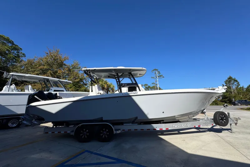 Slide: The Image of 2023 Fountain 34 Tournament Edition boat on trailer under clear blue sky. - 9