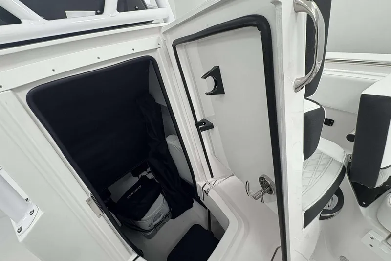 Slide: The Image of 2026 Blackfin 222 CC boat interior with open storage compartment and seating. - 12