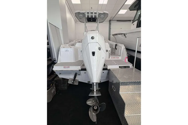 Slide: The Image of 2026 Blackfin 222 CC boat with outboard motor in showroom. - 18