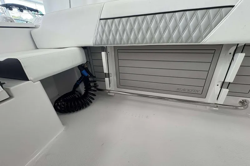 Slide: The Image of Interior of 2026 Blackfin 222 CC boat, featuring sleek seating and storage. - 21
