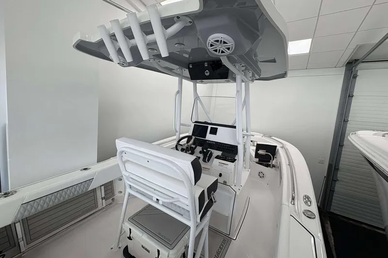 Slide: The Image of 2026 Blackfin 222 CC boat interior with modern helm and seating in showroom. - 3