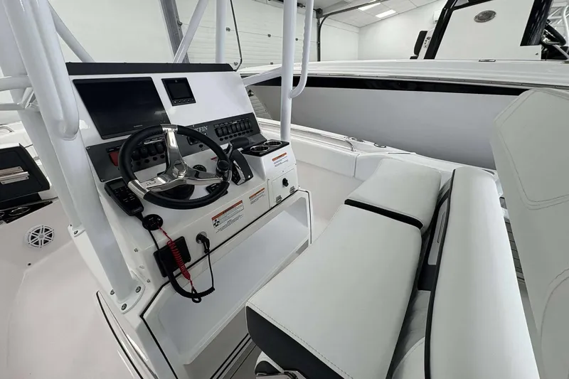 Slide: The Image of 2026 Blackfin 222 CC boat interior with modern steering console and seating. - 5