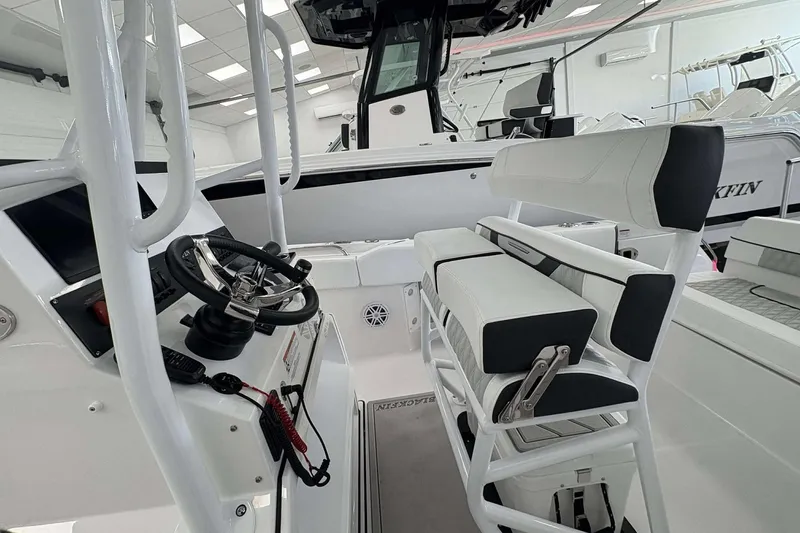 Slide: The Image of 2026 Blackfin 222 CC boat interior with steering wheel and seating. - 6