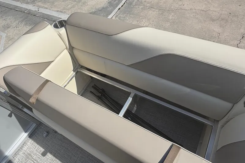 Slide: The Image of 2026 Tahoe Pontoon 21 boat interior with beige seating and under-seat storage. - 5